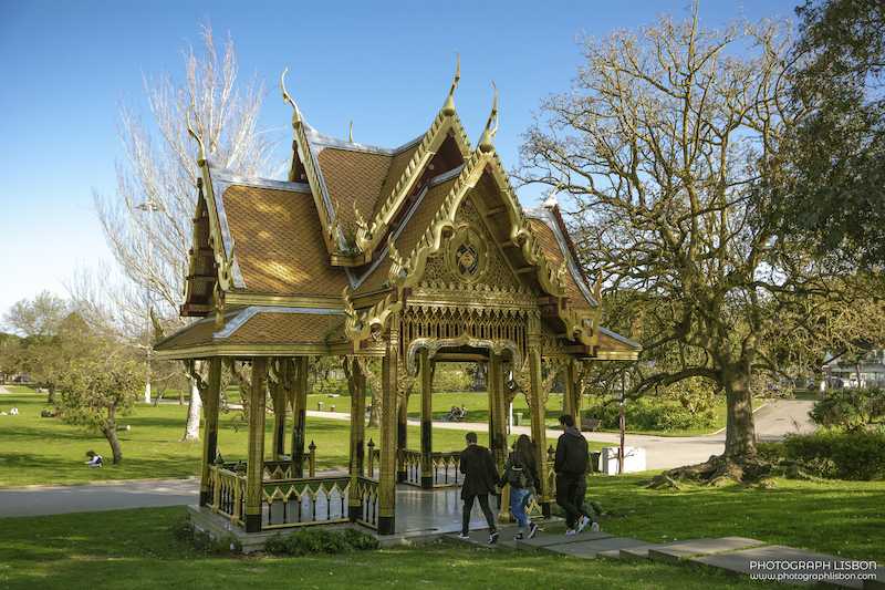 Golden Thai pavilion in Jardim Vasco da Gama with visitors approaching, Belém, Lisbon.